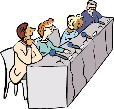 Vorne sitzen ein paar Menschen. Sie sprechen miteinander und beantworten Fragen.